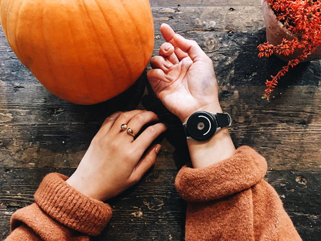 woman wearing doppel near a pumpkin