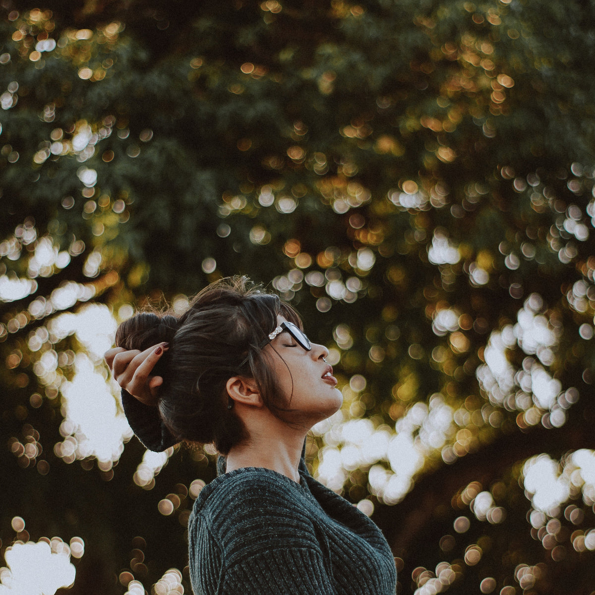 women wearing glasses breathing deeply sign of relief in a park 